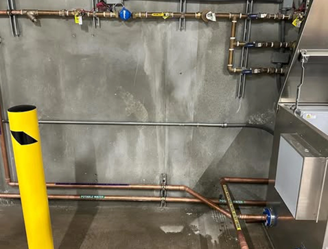 An interior space featuring an intricate arrangement of pipes, highlighting the structural and functional aspects of the room An interior space featuring an intricate arrangement of pipes, highlighting the structural and functional aspects of the room