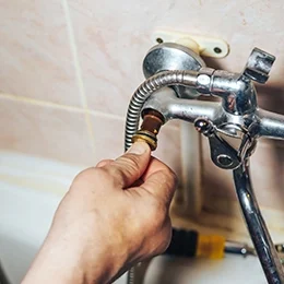 Man repair and fixing leaky faucet in bathroom Man repair and fixing leaky faucet in bathroom