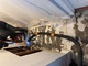 A worker is installing a thermal head on the home heating system distributor.